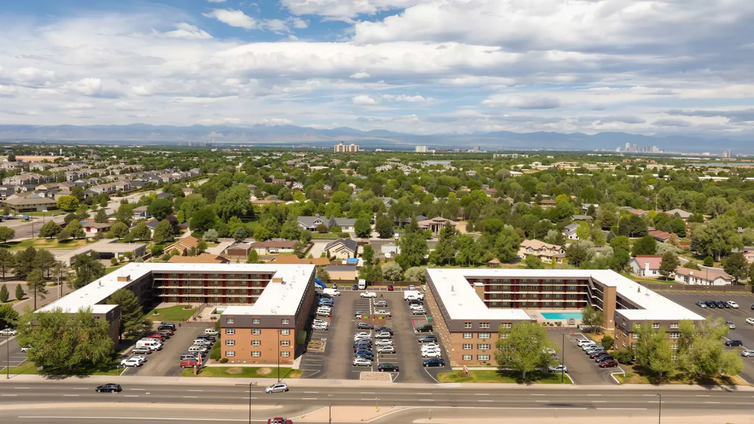 Aerial view of Meridian Garden Apartments surrounded by Denver neighborhoods and mountain views